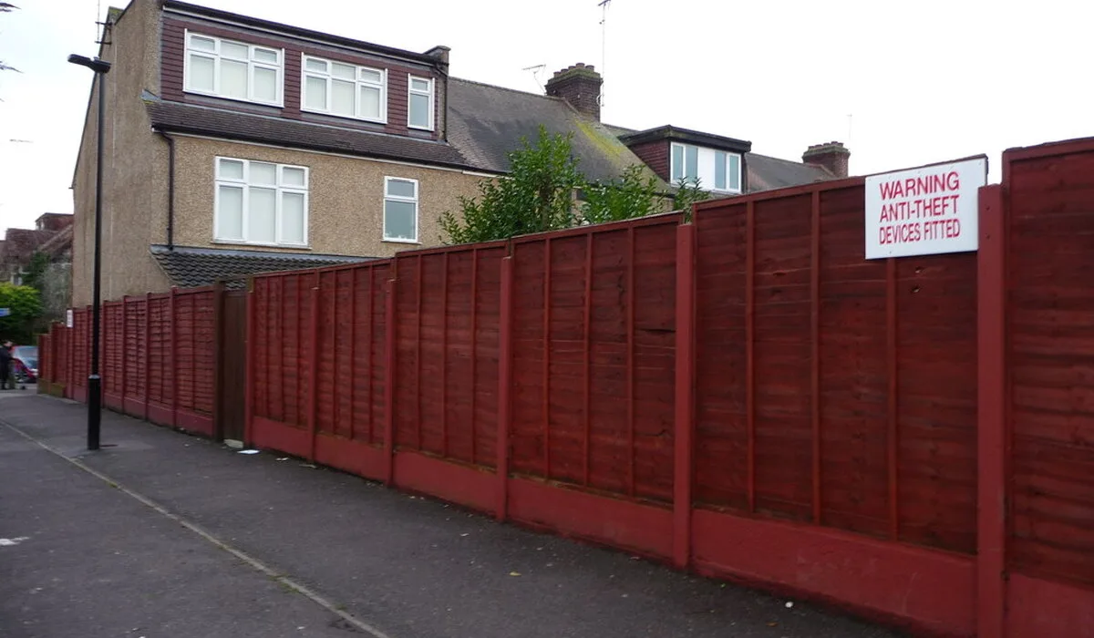 Boundary dispute surveyor example, a long garden fence marking the boundary between homes and a footpath
