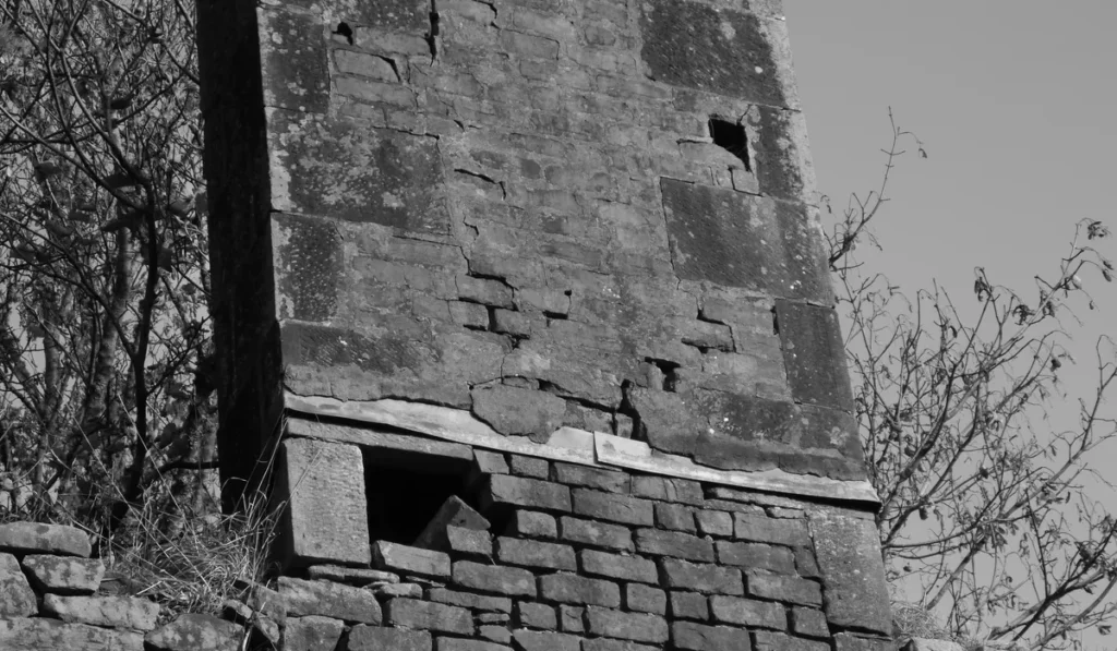 Chimney breast removal often starts with an old brick chimney breast like this one in a UK house